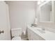 Bright bathroom with a white vanity, sink, and toilet at 201 Nouveau Sw Ct, Lilburn, GA 30047