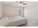 Carpeted bedroom featuring a ceiling fan, a bed, and a window for natural light at 201 Nouveau Sw Ct, Lilburn, GA 30047