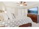 Bedroom featuring a large bed and a dresser with a TV on it at 201 Nouveau Sw Ct, Lilburn, GA 30047