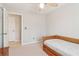 Cozy bedroom featuring a ceiling fan, a twin-sized bed and a door to another room at 201 Nouveau Sw Ct, Lilburn, GA 30047