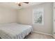 Bedroom featuring a bed with a view of the outdoors from the window at 201 Nouveau Sw Ct, Lilburn, GA 30047