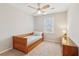 Well-lit bedroom featuring a trundle bed and ceiling fan at 201 Nouveau Sw Ct, Lilburn, GA 30047