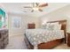 Cozy bedroom featuring a ceiling fan and large bed with drawers at 201 Nouveau Sw Ct, Lilburn, GA 30047