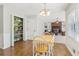 Open dining area adjacent to a pantry and living room with natural light and wood floors at 201 Nouveau Sw Ct, Lilburn, GA 30047