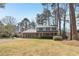 A quaint two-story home with blue siding, a brick facade, and a lush green front yard at 201 Nouveau Sw Ct, Lilburn, GA 30047