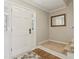 Bright foyer featuring hardwood floors, a mirror, and a glimpse of the staircase at 201 Nouveau Sw Ct, Lilburn, GA 30047