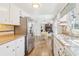 Bright kitchen with stainless steel refrigerator and views of the dining and living areas at 201 Nouveau Sw Ct, Lilburn, GA 30047