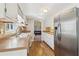 Well-lit kitchen with stainless steel refrigerator and tile backsplash at 201 Nouveau Sw Ct, Lilburn, GA 30047