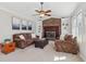 Comfortable living room featuring a brick fireplace, built-in shelves, and ceiling fan at 201 Nouveau Sw Ct, Lilburn, GA 30047