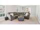 Spacious living room with a large sectional sofa, an ottoman, and bright lighting at 201 Nouveau Sw Ct, Lilburn, GA 30047