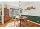 Dining room features wood table and chairs, and green accent wall at 2667 Flair Knoll Ne Dr, Atlanta, GA 30345