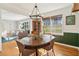 Charming dining room with wood table, wicker chairs, and green accent wall at 2667 Flair Knoll Ne Dr, Atlanta, GA 30345