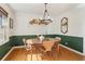 Sunlit dining room with wood table, chairs, and green wainscoting at 2667 Flair Knoll Ne Dr, Atlanta, GA 30345