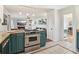 Modern kitchen with island, teal cabinets, and stainless steel appliances at 2667 Flair Knoll Ne Dr, Atlanta, GA 30345