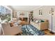 Sunlit living room with hardwood floors, comfy seating, and a view to the dining area at 2667 Flair Knoll Ne Dr, Atlanta, GA 30345