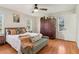 Main bedroom with hardwood floors, a comfy bed, and built-in shelving at 2667 Flair Knoll Ne Dr, Atlanta, GA 30345