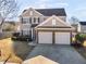 Two-story house with a two-car garage and a front yard at 11602 Kades Trl, Hampton, GA 30228