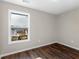 Bright bedroom with dark brown wood floors and a large window at 11602 Kades Trl, Hampton, GA 30228