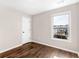 Well-lit bedroom with wood floors, a window, and a door at 11602 Kades Trl, Hampton, GA 30228