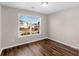 Bright bedroom with large window and dark hardwood floors at 11602 Kades Trl, Hampton, GA 30228