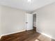 Bedroom with hardwood floors, neutral walls, and access to hallway at 11602 Kades Trl, Hampton, GA 30228