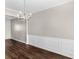 Dining room features hardwood floors and wainscoting at 11602 Kades Trl, Hampton, GA 30228