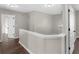 Upstairs hallway with neutral walls and wood-look floors at 11602 Kades Trl, Hampton, GA 30228