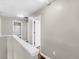 Upstairs hallway with neutral walls and hardwood floors at 11602 Kades Trl, Hampton, GA 30228