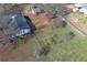 An aerial view of a home featuring a fenced yard and detached outbuildings at 1349 Highway 81 E, Mcdonough, GA 30252