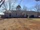 View of the back of the house from the backyard with a deck and plenty of space at 1349 Highway 81 E, Mcdonough, GA 30252