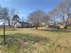 Backyard with a shed, trailer, and mature trees, offering a serene outdoor setting at 1349 Highway 81 E, Mcdonough, GA 30252