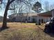 Back of the house showing a backyard with a patio, shed, and mature trees at 1349 Highway 81 E, Mcdonough, GA 30252