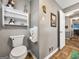 Simple bathroom with a toilet and built-in shelving at 1349 Highway 81 E, Mcdonough, GA 30252