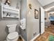 Cozy bathroom features gray walls, white fixtures, and a decorative shelf adding personality to the space at 1349 Highway 81 E, Mcdonough, GA 30252