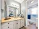 Bright bathroom vanity with a neutral countertop and ample storage, flowing into the toilet and shower area at 1349 Highway 81 E, Mcdonough, GA 30252