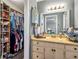 Functional bathroom featuring a sink vanity with storage and an adjacent walk-in closet for ample space at 1349 Highway 81 E, Mcdonough, GA 30252