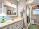 Bathroom featuring white vanity, glass-enclosed shower, decorative mirror, and neutral walls at 1349 Highway 81 E, Mcdonough, GA 30252