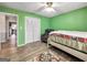 Bedroom with green walls, ceiling fan, and wood-look floors at 1349 Highway 81 E, Mcdonough, GA 30252