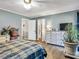 Bright bedroom featuring wood floors, light walls, a ceiling fan, and easy access to the en suite bathroom at 1349 Highway 81 E, Mcdonough, GA 30252