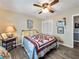 Bedroom with wood floors, ceiling fan, quilt bedding, neutral walls, and white closet at 1349 Highway 81 E, Mcdonough, GA 30252