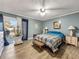 Spacious bedroom boasting natural light, a ceiling fan, and a private deck through elegant navy curtains at 1349 Highway 81 E, Mcdonough, GA 30252