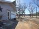 View of the driveway leading to the garage with a charming exterior and a well-kept lawn at 1349 Highway 81 E, Mcdonough, GA 30252