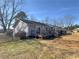 Exterior of the home highlighting the backyard with a deck and mature trees at 1349 Highway 81 E, Mcdonough, GA 30252