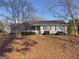 Charming single-story home featuring a well-maintained lawn and mature trees at 1349 Highway 81 E, Mcdonough, GA 30252