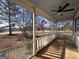 Covered porch with white railings and view of trees and yard at 1349 Highway 81 E, Mcdonough, GA 30252