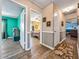 Hallway connects multiple rooms with wood floors and neutral walls, offering a view into the living spaces at 1349 Highway 81 E, Mcdonough, GA 30252