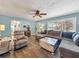 Inviting living room with a comfy sectional sofa, neutral armchair, wood-look flooring, and a bright window view at 1349 Highway 81 E, Mcdonough, GA 30252