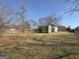 Open grassy yard with shed in the distance at 1349 Highway 81 E, Mcdonough, GA 30252