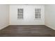 Spacious bedroom with two windows and dark floors at 1853 Edington Sw Rd, Marietta, GA 30064