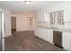 Kitchen boasts white cabinets, stainless steel appliances, and wood-look floors at 1853 Edington Sw Rd, Marietta, GA 30064